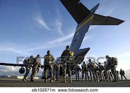 Soldiers prepare to board a C-17 Globemaster III. View Large Photo Image Picture - Soldiers prepare to board a C-17 Globemaster III.. Fotosearch