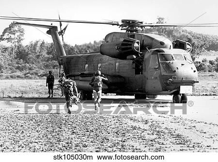 Soldiers run to a HH-53C helicopter during an asualt on Koh Tang Island. View Large Photo Image Picture - Soldiers run to a HH-53C helicopter during an asualt on Koh Tang Island.. Fotosearch