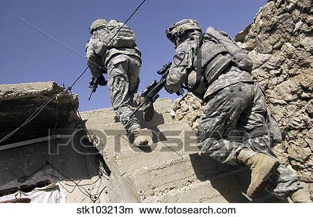 Soldiers running up staircase of a building during a mission in Mosul, Iraq. View Large Photo Image Picture - Soldiers running up staircase of a building during a mission in Mosul, Iraq. . Fotosearch
