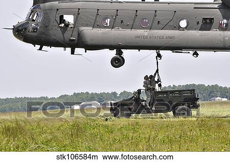 Soldiers teach students sling load operations on a CH-47 Chinook. View Large Photo Image Picture - Soldiers teach students sling load operations on a CH-47 Chinook.. Fotosearch