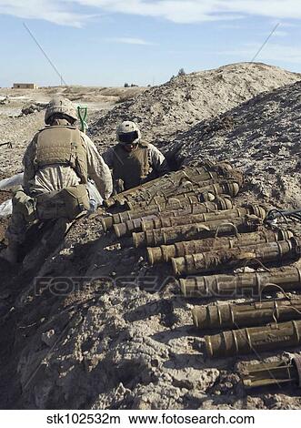 Soldiers unearth 82mm Chinese mortars from a weapons cache. View Large Photo Image Picture - Soldiers unearth 82mm Chinese mortars from a weapons cache.. Fotosearch