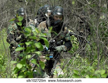 Soldiers walking through brush during training. View Large Photo Image Picture - Soldiers walking through brush during training.. Fotosearch