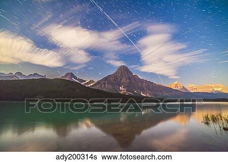 Space station passing west to east over Mt. Chephren in Banff National Park, Canada. View Large Photo Image Stock Photograph - Space station passing west to east over Mt. Chephren in Banff National Park, Canada.. Fotosearch