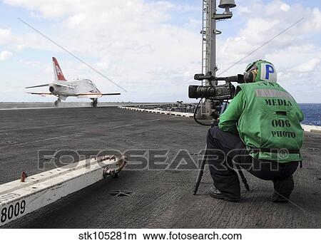 Specialist records video of flight deck operations. View Large Photo Image Picture - Specialist records video of flight deck operations.. Fotosearch