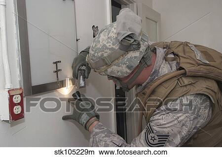 Specialist takes a photograph of evidence during a battlefield forensics course. View Large Photo Image Picture - Specialist takes a photograph of evidence during a battlefield forensics course.. Fotosearch