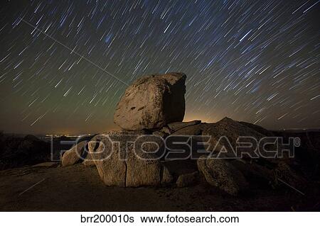 Stock Photograph - Star trails and large boulders Anza Borrego Desert State Park, California.. Fotosearch