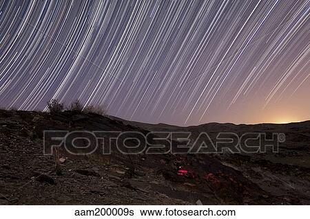 Stock Photograph - Star trails and rock art in the central province of Iran.. Fotosearch