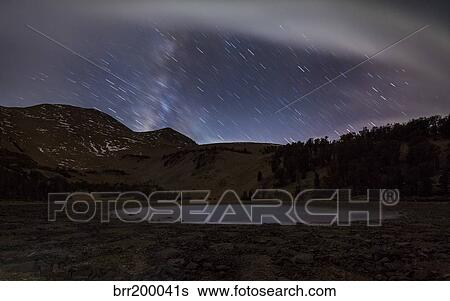 Star trails and the blurred band of the Milky Way above a lake in the Eastern Sierra Nevada. View Large Photo Image Stock Photograph - Star trails and the blurred band of the Milky Way above a lake in the Eastern Sierra Nevada.. Fotosearch