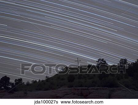 Star trails arch over a cross on a hill in Oklahoma. View Large Photo Image Stock Photograph - Star trails arch over a cross on a hill in Oklahoma.. Fotosearch