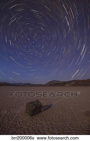Stock Photograph - Star trails at the Racetrack Playa in Death Valley National Park, California.. Fotosearch