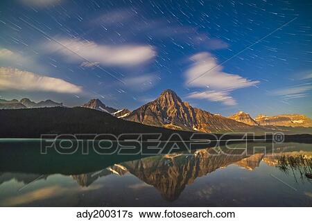 Star trails behind Mount Chephren in Banff National Park, Canada. View Large Photo Image Stock Photograph - Star trails behind Mount Chephren in Banff National Park, Canada.. Fotosearch