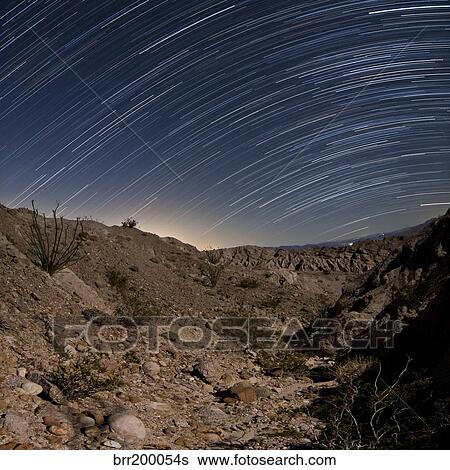 Stock Photograph - Star trails over the rugged canyon in Anza Borrego Desert State Park, California.. Fotosearch
