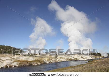 Steam rising over Midway Geyser Basin geothermal area, Yellowstone National Park, Wyoming. View Large Photo Image Stock Photograph - Steam rising over Midway Geyser Basin geothermal area, Yellowstone National Park, Wyoming.. Fotosearch