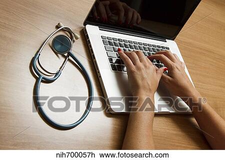 Stock Image - Stethoscope and laptop computer.. Fotosearch