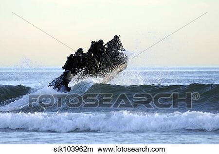 Students in Navy SEALs qualification training navigate the surf off the cost of Coronado. View Large Photo Image Picture - Students in Navy SEALs qualification training navigate the surf off the cost of Coronado.. Fotosearch