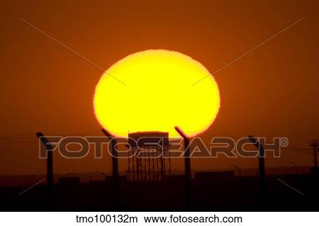 Picture - Sunrise over Camp Wolfe with an old Iraqi water tower in the foreground.. Fotosearch