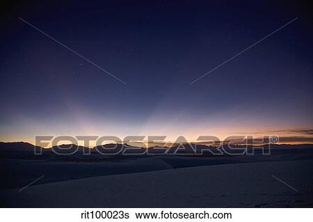 Stock Photograph - Sunset landscape depicting crepuscular rays.. Fotosearch