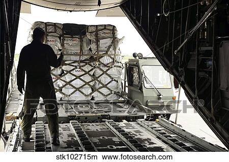 Supplies are loaded into a C-130 Hercules. View Large Photo Image Picture - Supplies are loaded into a C-130 Hercules.. Fotosearch