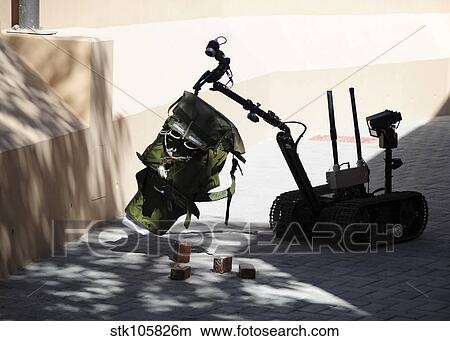 Talon remote-controlled robot investigates an improvised explosive device. View Large Photo Image Picture - Talon remote-controlled robot investigates an improvised explosive device.. Fotosearch