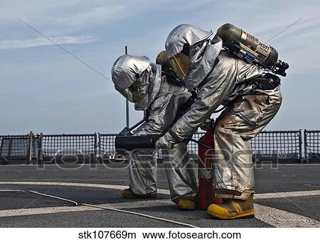 Technicians check for hot spots during a firefighting drill aboard USS Tortuga. View Large Photo Image Picture - Technicians check for hot spots during a firefighting drill aboard USS Tortuga.. Fotosearch