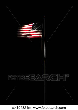 The American flag flies over Naval Station Guantanamo Bay, Cuba. View Large Photo Image Picture - The American flag flies over Naval Station Guantanamo Bay, Cuba.. Fotosearch