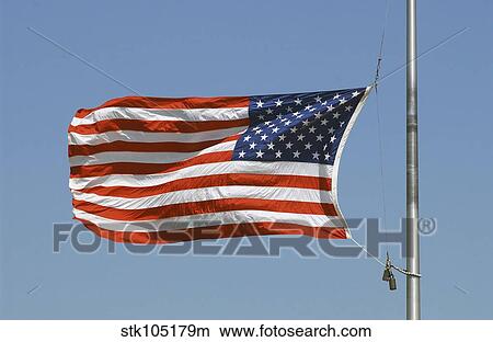 The American flag waves at half-mast. View Large Photo Image Picture - The American flag waves at half-mast.. Fotosearch