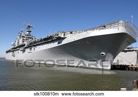 The amphibious assault ship USS Nassau sits moored in port. View Large Photo Image Picture - The amphibious assault ship USS Nassau sits moored in port.. Fotosearch