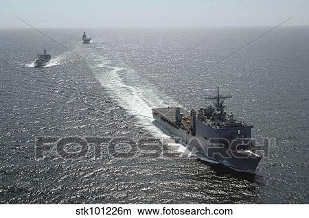 The amphibious dock landing ship USS Carter Hall breaks away following a replenishment at sea. View Large Photo Image Picture - The amphibious dock landing ship USS Carter Hall breaks away following a replenishment at sea.. Fotosearch