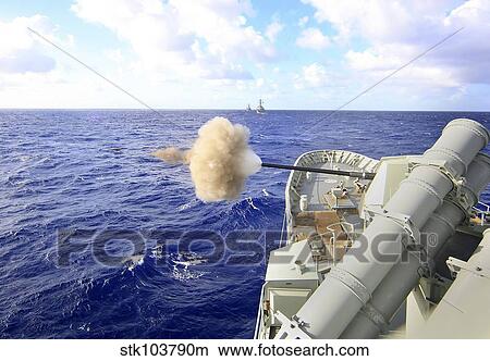 The Australian navy frigate HMAS Warramunga fires its 5-inch gun during a surface engagement. View Large Photo Image Picture - The Australian navy frigate HMAS Warramunga fires its 5-inch gun during a surface engagement.. Fotosearch