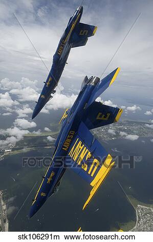 The Blue Angels perform a looping maneuver over Pensacola Beach, Florida. View Large Photo Image Picture - The Blue Angels perform a looping maneuver over Pensacola Beach, Florida.. Fotosearch