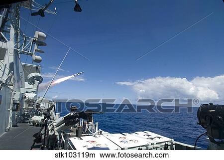 Picture - The Canadian frigate HMCS Regina firing a Harpoon anti-ship missile during a Rim of the Pacific sinking exercise.. Fotosearch