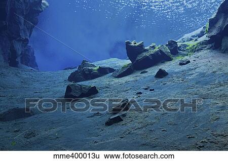 Stock Photograph - The clear water of the lagoon at Silfra Crack, Iceland.. Fotosearch