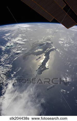 The island of Hispaniola with sunglint illuminating the peninsula of Haiti. View Large Photo Image Stock Photograph - The island of Hispaniola with sunglint illuminating the peninsula of Haiti.. Fotosearch