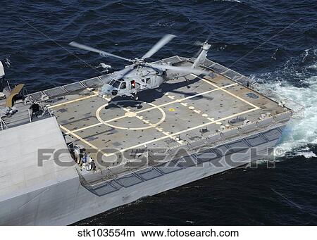 The littoral combat ship USS Freedom with an MH-60S Sea Hawk helicopter. View Large Photo Image Picture - The littoral combat ship USS Freedom with an MH-60S Sea Hawk helicopter.. Fotosearch