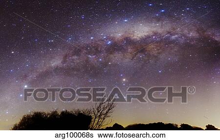 Stock Photograph - The Milky Way above a rural landscape in San Pedro, Argentina.. Fotosearch