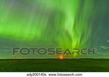 Stock Photograph - The northern lights as seen from the Wintering Hills Wind Farm, Alberta, Canada.. Fotosearch