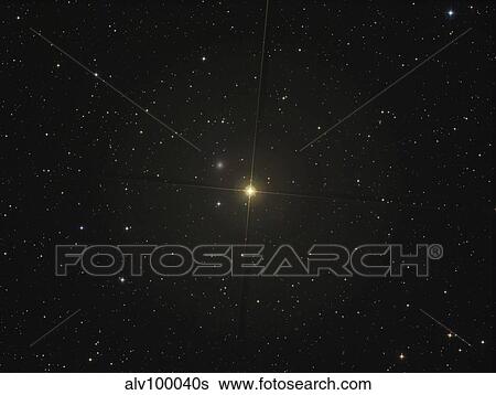 The red giant star Beta Andromedae and its ghost galaxy NGC 404. View Large Photo Image Stock Photograph - The red giant star Beta Andromedae and its ghost galaxy NGC 404.. Fotosearch