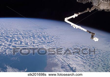 The robotic Canadarm2 above Earth. View Large Photo Image Stock Photograph - The robotic Canadarm2 above Earth.. Fotosearch