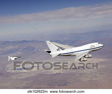 The SOFIA infrared observatory and F/A-18 safety chase during a test flight. View Large Photo Image Picture - The SOFIA infrared observatory and F/A-18 safety chase during a test flight.. Fotosearch