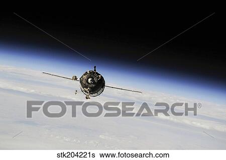 The Soyuz TMA-10M spacecraft in orbit above Earth. View Large Photo Image Stock Photograph - The Soyuz TMA-10M spacecraft in orbit above Earth.. Fotosearch