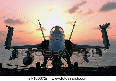 The sun rises on an F/A-18 Hornet. View Large Photo Image Picture - The sun rises on an F/A-18 Hornet.. Fotosearch