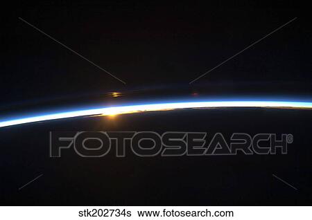 The thin line of Earth's atmosphere and the rising sun. View Large Photo Image Stock Photograph - The thin line of Earth's atmosphere and the rising sun.. Fotosearch