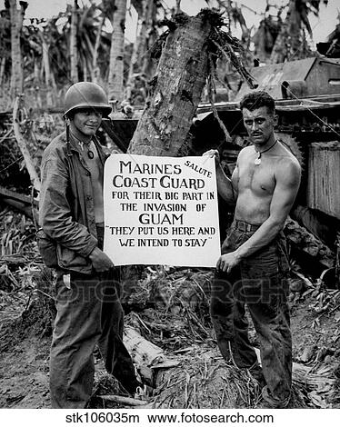 Picture - The U. S. Marines salute the U. S. Coast Guard after teh battle for Guam.. Fotosearch
