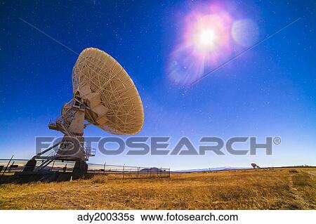 Stock Photograph - The Very Large Array radio telescope under moonlight in New Mexico.. Fotosearch