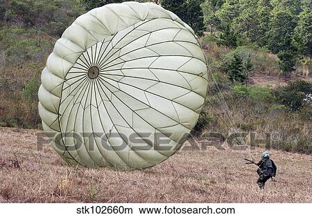 The wind pushes a Honduran soldier's chute after he lands safely. View Large Photo Image Picture - The wind pushes a Honduran soldier's chute after he lands safely.. Fotosearch