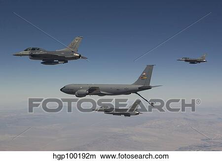 Three F-16's join up with a KC-135 over Arizona. View Large Photo Image Picture - Three F-16's join up with a KC-135 over Arizona.. Fotosearch
