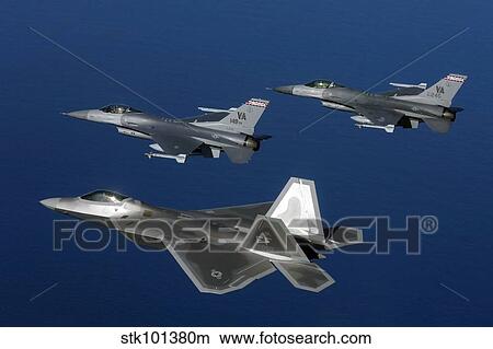 Three F-22A Raptor aircrafts fly in formation. View Large Photo Image Picture - Three F-22A Raptor aircrafts fly in formation.. Fotosearch