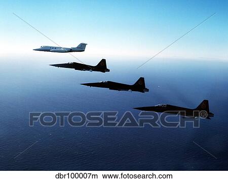 Picture - Three F-5E Tiger IIs fly in formation with a Learjet 25.. Fotosearch