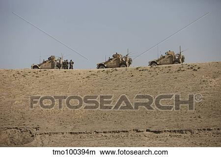 Three M-ATV's guard the top of the wadi near Kunduz, Afghanistan. View Large Photo Image Picture - Three M-ATV's guard the top of the wadi near Kunduz, Afghanistan.. Fotosearch