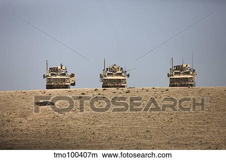 Picture - Three M-ATV's guard the top of the wadi near Kunduz, Afghanistan.. Fotosearch